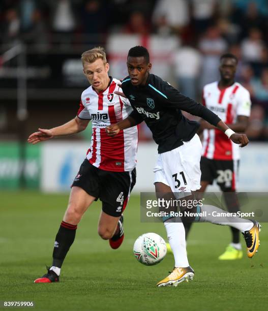 West Ham United's Edimilson Fernandes and Cheltenham Town's Kyle Storer during the Carabao Cup Second Round match between Cheltenham Town and West...