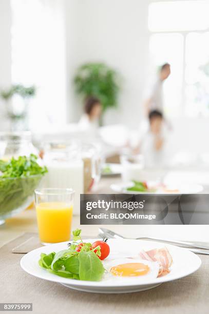 served table with family in background, focus on foreground - light vivid children senior young focus foto e immagini stock