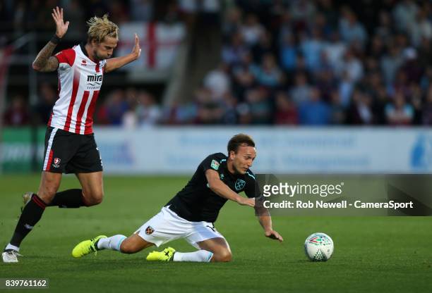 Cheltenham Town's Harry Pell takes down West Ham United's Mark Noble during the Carabao Cup Second Round match between Cheltenham Town and West Ham...