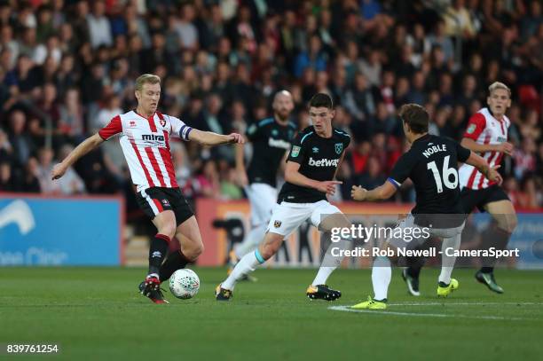 Cheltenham Town's Kyle Storer and West Ham United's Declan Rice during the Carabao Cup Second Round match between Cheltenham Town and West Ham United...