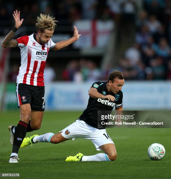 Cheltenham Town's Harry Pell takes down West Ham United's Mark Noble during the Carabao Cup Second Round match between Cheltenham Town and West Ham...