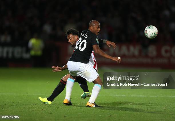 West Ham United's Andre Ayew and Cheltenham Town's Jordan Cranston during the Carabao Cup Second Round match between Cheltenham Town and West Ham...