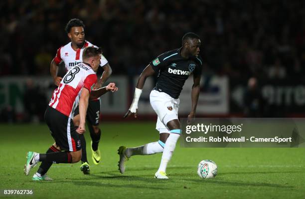 West Ham United's Cheikhou Kouyate and Cheltenham Town's Kevin Dawson during the Carabao Cup Second Round match between Cheltenham Town and West Ham...