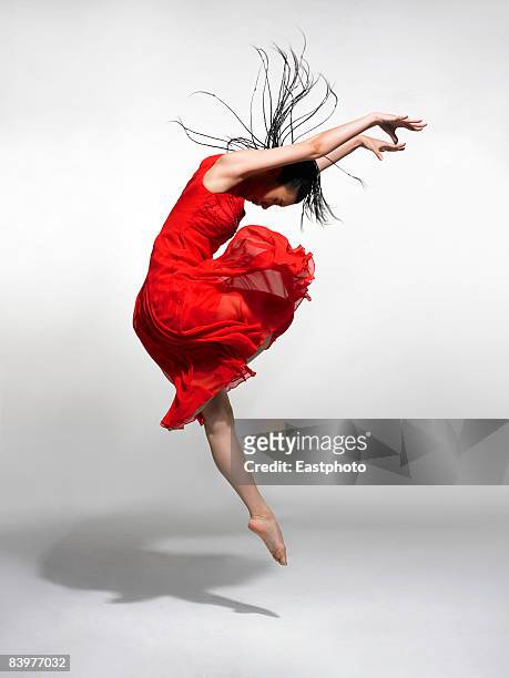 woman dancing. - red dress stock pictures, royalty-free photos & images