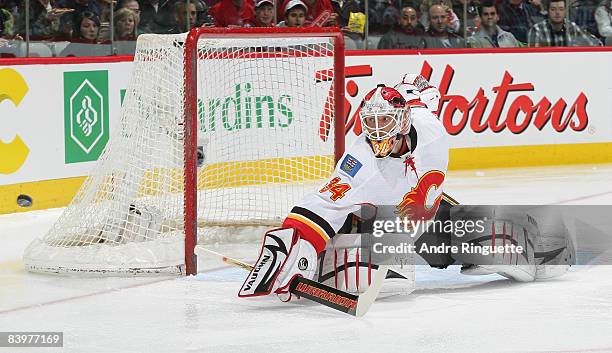 Miikka Kiprusoff of the Calgary Flames makes a blocker save against the Montreal Canadiens at the Bell Centre on December 9, 2008 in Montreal,...