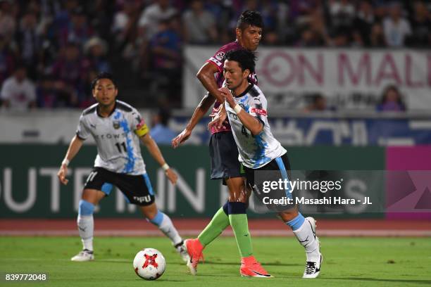 Akihiro Ienaga of Kawasaki Frontale is fouled by Eder Lima of Ventforet Kofu resulting in the penalty kick during the J.League J1 match between...