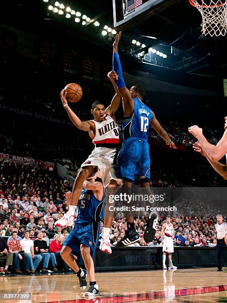 Nicolas Batum of the Portland Trail Blazers passes the ball around Dwight Howard of the Orlando Magic during a game on December 9, 2008 at the Rose...