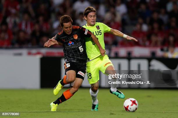 Shoma Kamata of Shimizu S-Pulse and Daisuke Kikuchi of Urawa Red Diamonds compete for the ball during the J.League J1 match between Shimizu S-Pulse...