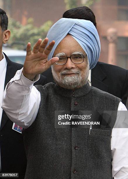 Indian Prime Minister Manmohan Singh waves on his arrival at Parliament house in New Delhi on December 10, 2008 to attend the opening of the third...