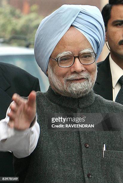 Indian Prime Minister Manmohan Singh waves on his arrival at Parliament house in New Delhi on December 10, 2008 to attend the opening of the third...