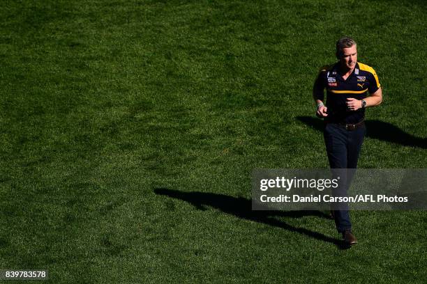 Adam Simpson, coach of the Eagles makes his way to the coaches box during the 2017 AFL round 23 match between the West Coast Eagles and the Adelaide...