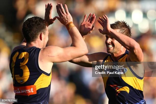 Luke Shuey and Mark LeCras of the Eagles celebrate a goal during the round 23 AFL match between the West Coast Eagles and the Adelaide Crows at...