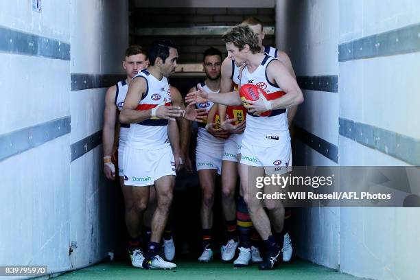 Rory Sloane of the Crows leads the team out onto the field during the round 23 AFL match between the West Coast Eagles and the Adelaide Crows at...