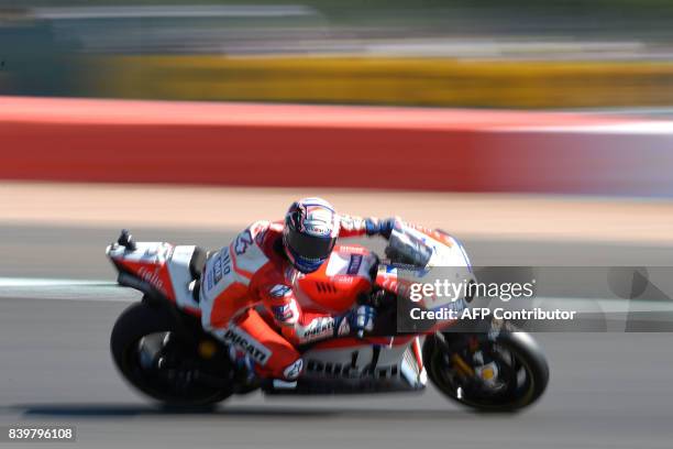 Ducati Team's Italian rider Andrea Dovizioso exits Village Corner during the MotoGP Warm Up session of the British Grand Prix at Silverstone circuit...