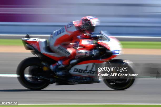 Ducati Team's Italian rider Andrea Dovizioso exits Village Corner during the MotoGP Warm Up session of the British Grand Prix at Silverstone circuit...