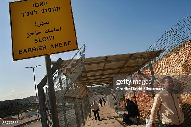 Palestinians pass through the Israeli army's checkpoint at Reihan October 30, 2008 where Israel's separation barrier cuts the Palestinian villages of...