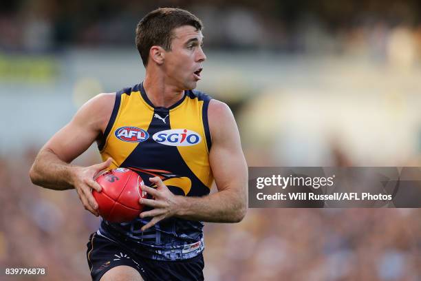 Jamie Cripps of the Eagles runs with the ball during the round 23 AFL match between the West Coast Eagles and the Adelaide Crows at Domain Stadium on...