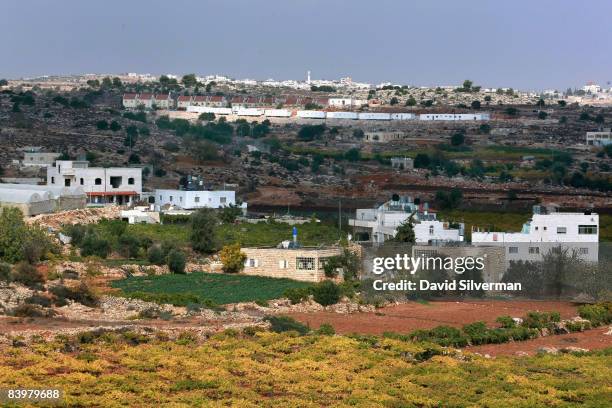 General view of Baqaa' village with the Israeli settlement of Kiryat Arba on the hills behind November 12, 2008 near Hebron in the West Bank. Cut off...