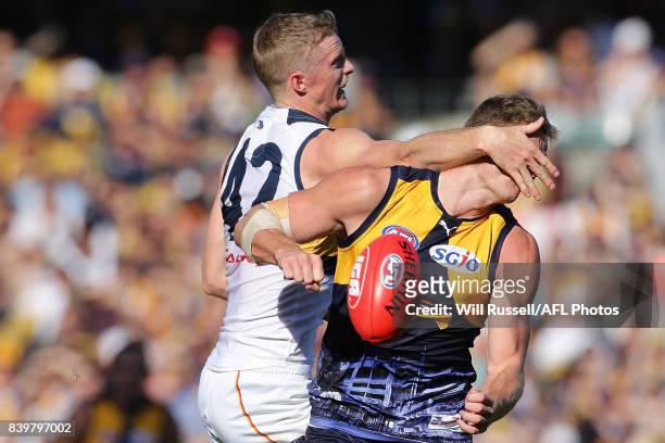 Nathan Vardy of the Eagles is hit in the face by Alex Keath of the Crows during the round 23 AFL match between the West Coast Eagles and the Adelaide...