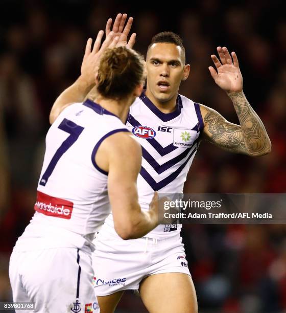 Harley Bennell of the Dockers congratulates Nat Fyfe of the Dockers on a goal during the 2017 AFL round 23 match between the Essendon Bombers and the...