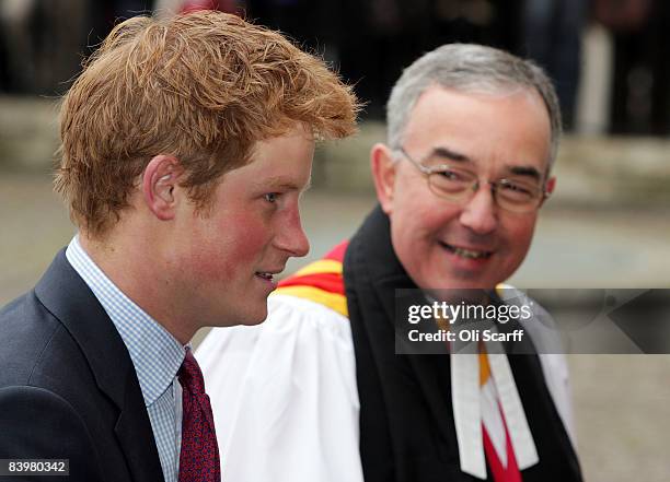 Prince Harry is greeted by The Very Reverend Dr John Hall, the Dean of Westminster, as he arrives at a service to honor the "Woman's Own Children of...