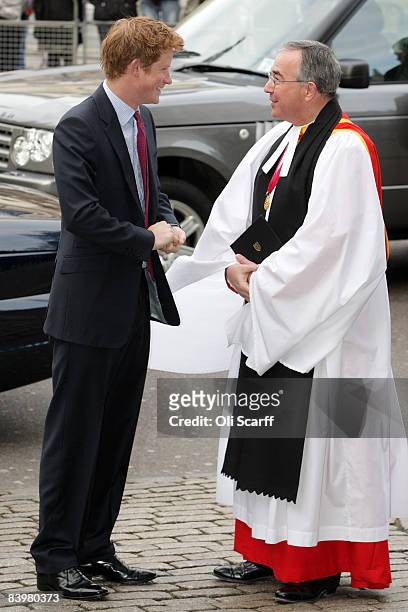 Prince Harry is greeted by The Very Reverend Dr John Hall, the Dean of Westminster, as he arrives at a service to honor the "Woman's Own Children of...