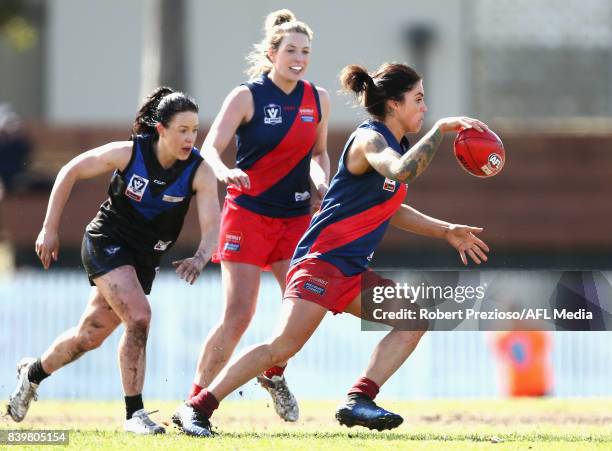 Sophie Abbatangelo of Diamond Creek kicks during the round 14 Women's VFL match between Melbourne University and Diamond Creek at Melbourne...