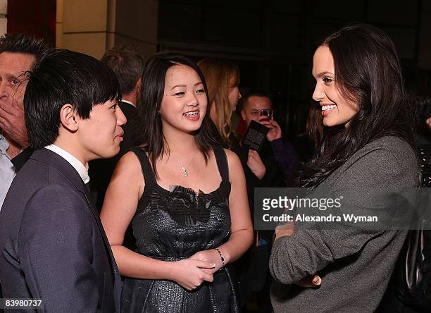 Bee Vang, Ahney Her, and Angelina Jolie arrive on the red carpet for the Los Angeles premiere of "Gran Torino" at the Steven J. Ross Theater on The...