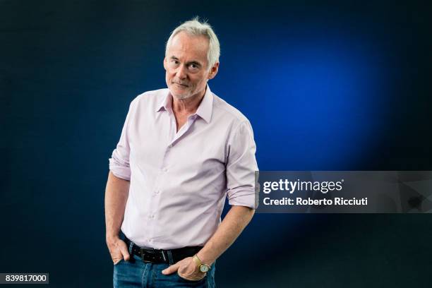 British author and radio/television presenter Martin Sixsmith attends a photocall during the annual Edinburgh International Book Festival at...