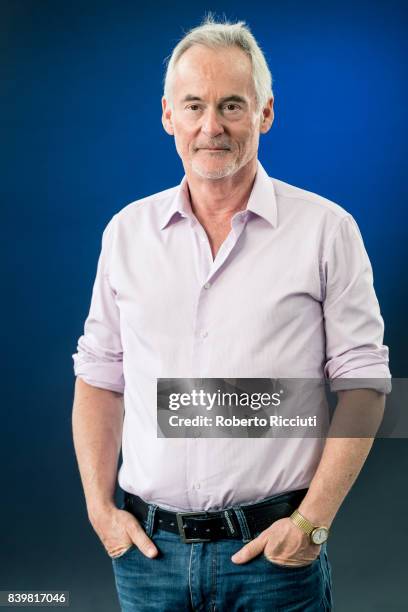 British author and radio/television presenter Martin Sixsmith attends a photocall during the annual Edinburgh International Book Festival at...