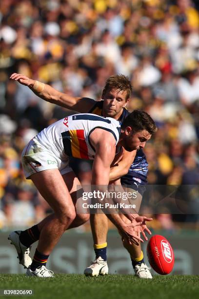 Rory Atkins of the Crows and Mark LeCras of the Eagles contest for the ball during the round 23 AFL match between the West Coast Eagles and the...