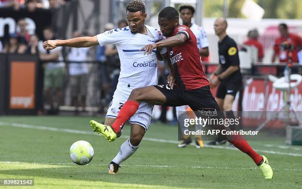 Guingamp's French defender Marcus Coco fights for the ball with Strasbourg's French defender Kenny Lala during the French Ligue 1 football match...