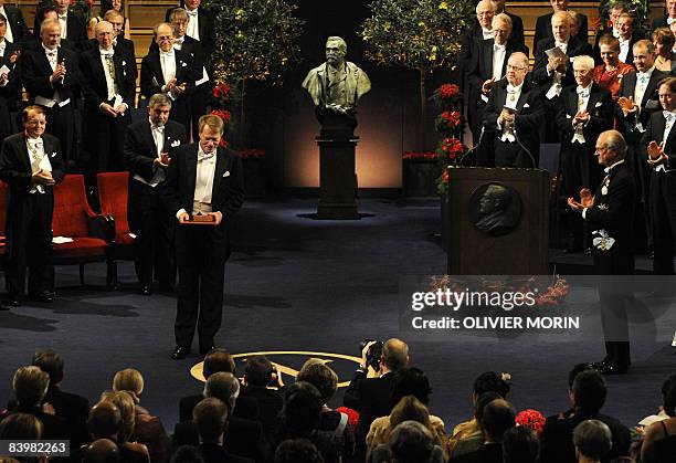 Nobel literature prize laureate Jean-Marie Le Clezio of France poses after receiving his award from Swedish King Carl XVI Gustaf in Stockholm on...