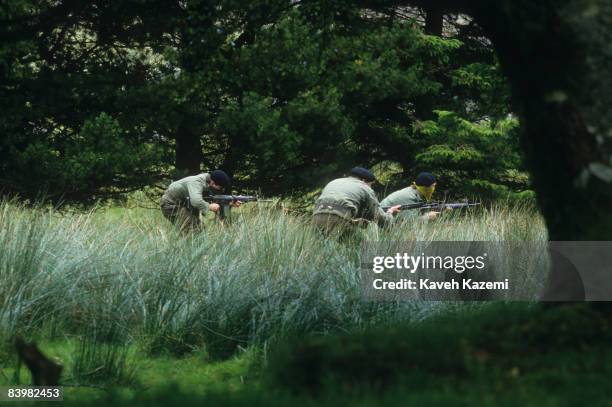 Trainee members of the Provisional Irish Republican Army practice guerilla warfare tactics in a secret location in the countryside possibly near the...