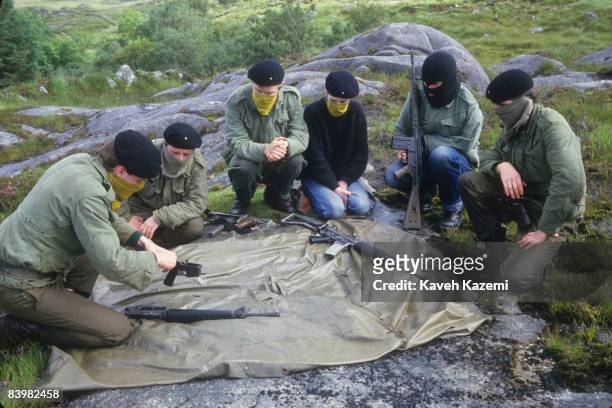 Trainee members of the Provisional Irish Republican Army undergo weapons training in a secret location in the countryside possibly near the border of...
