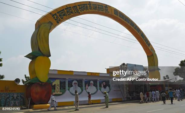 Followers of the controversial Indian guru Ram Rahim Singh are seen at the entrance of the 'Dera Sacha Sauda' ashram in Sirsa on August 27, 2017....