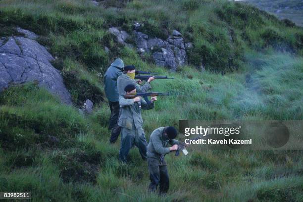 Trainee members of the Provisional Irish Republican Army practice guerilla warfare tactics in a secret location in the countryside possibly near the...