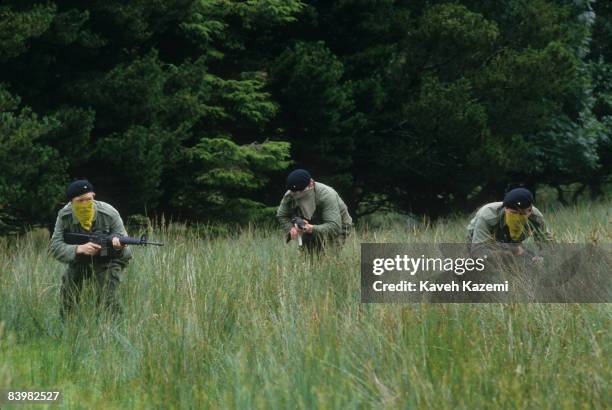 Trainee members of the Provisional Irish Republican Army practice guerilla warfare tactics in a secret location in the countryside possibly near the...