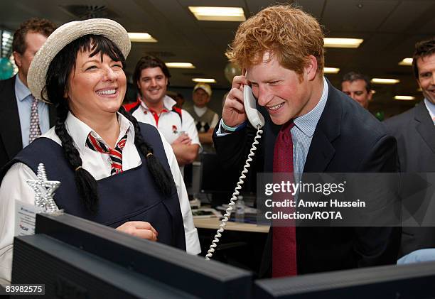 Prince Harry closes a deal with broker Amanda Hartnell at the offices of city traders ICAP on December 10, 2008 in London, England. The Prince...