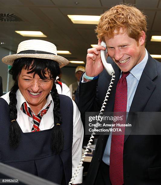 Prince Harry closes a deal with broker Amanda Hartnell at the offices of city traders ICAP on December 10, 2008 in London, England. The Prince...