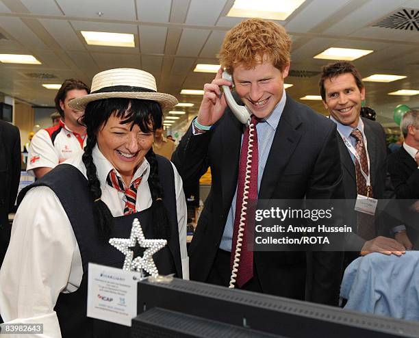 Prince Harry closes a deal with broker Amanda Hartnell at the offices of city traders ICAP on December 10, 2008 in London, England. The Prince...