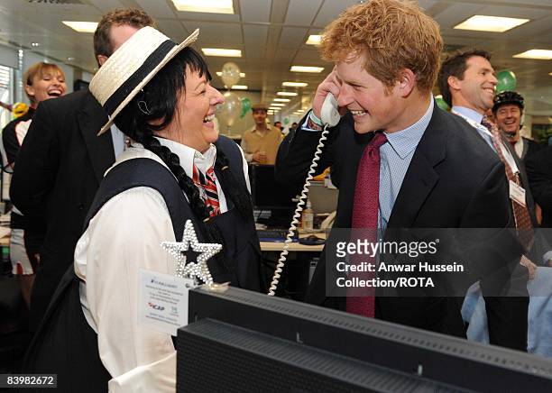 Prince Harry closes a deal with broker Amanda Hartnell at the offices of city traders ICAP on December 10, 2008 in London, England. The Prince...