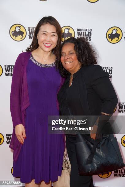 Director of Korean Churces for Community Development Hyepin Im and Director of Brotherhood Crusade Charisse Bremond attend the Buffalo Wild Wings...