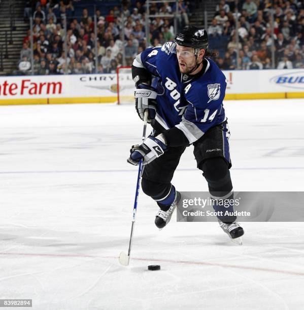 Andrej Meszaros of the Tampa Bay Lightning skates with the puck against the Buffalo Sabres at the St. Pete Times Forum on December 6, 2008 in Tampa,...