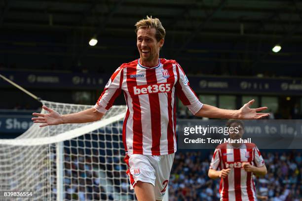 Peter Crouch of Stoke City celebrates scoring his sides first goal during the Premier League match between West Bromwich Albion and Stoke City at The...