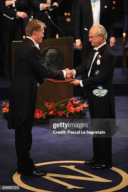 King Carl XVI Gustaf of Sweden hands the 2008 Nobel Prize in Literature to French writer Jean-Marie Gustave Le Clezio during the Nobel Foundation...