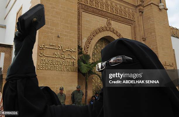 Fatiha Houssaini, wife of jailed Salafist, Omar Maarouf protests outside the headquarters of the council of human rights in Casablanca in Rabat on...