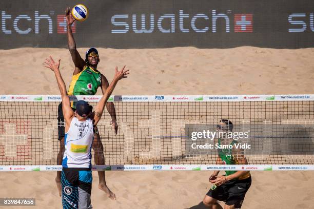 Evandro Goncalves Oliveira Junior of Brazil spikes the ball during the gold medal match against Phil Dalhausser and Nick Lucerna of the United States...