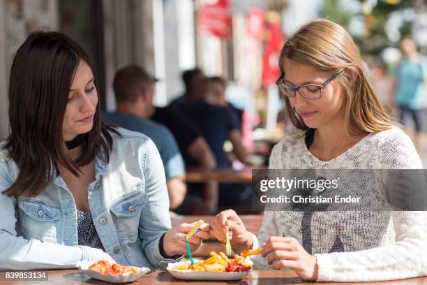 french fries and curry sausage - life in berlin kreuzberg - currywurst stock pictures, royalty-free photos & images