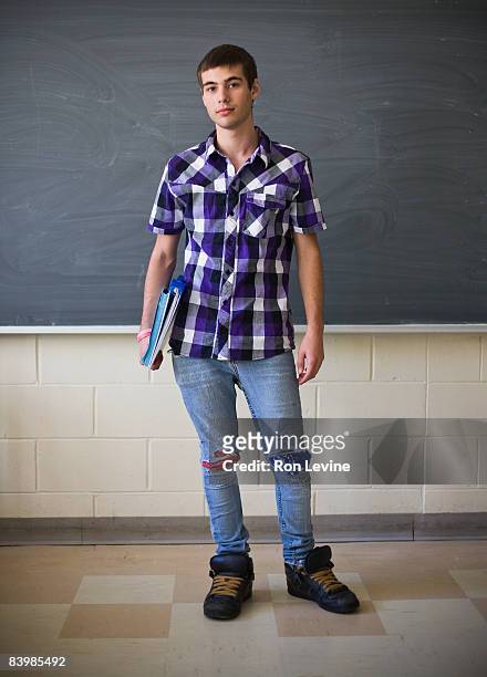 teen boy holding binders in classroom, portrait - blackboard qc stock pictures, royalty-free photos & images